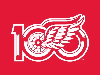 Red and white logo with the number 100 featuring a winged tire design.