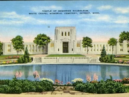 Temple with a reflecting pool and gardens, trees on both sides, under a blue sky.