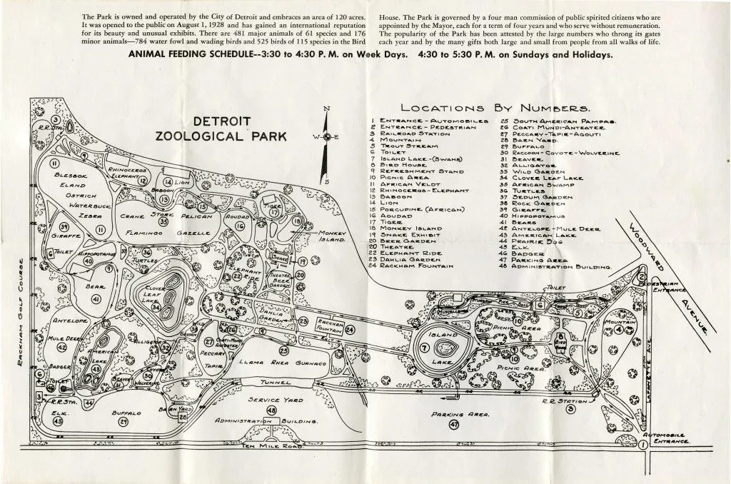 Map of Detroit Zoological Park with labeled locations and paths, featuring a compass and detailed layout.