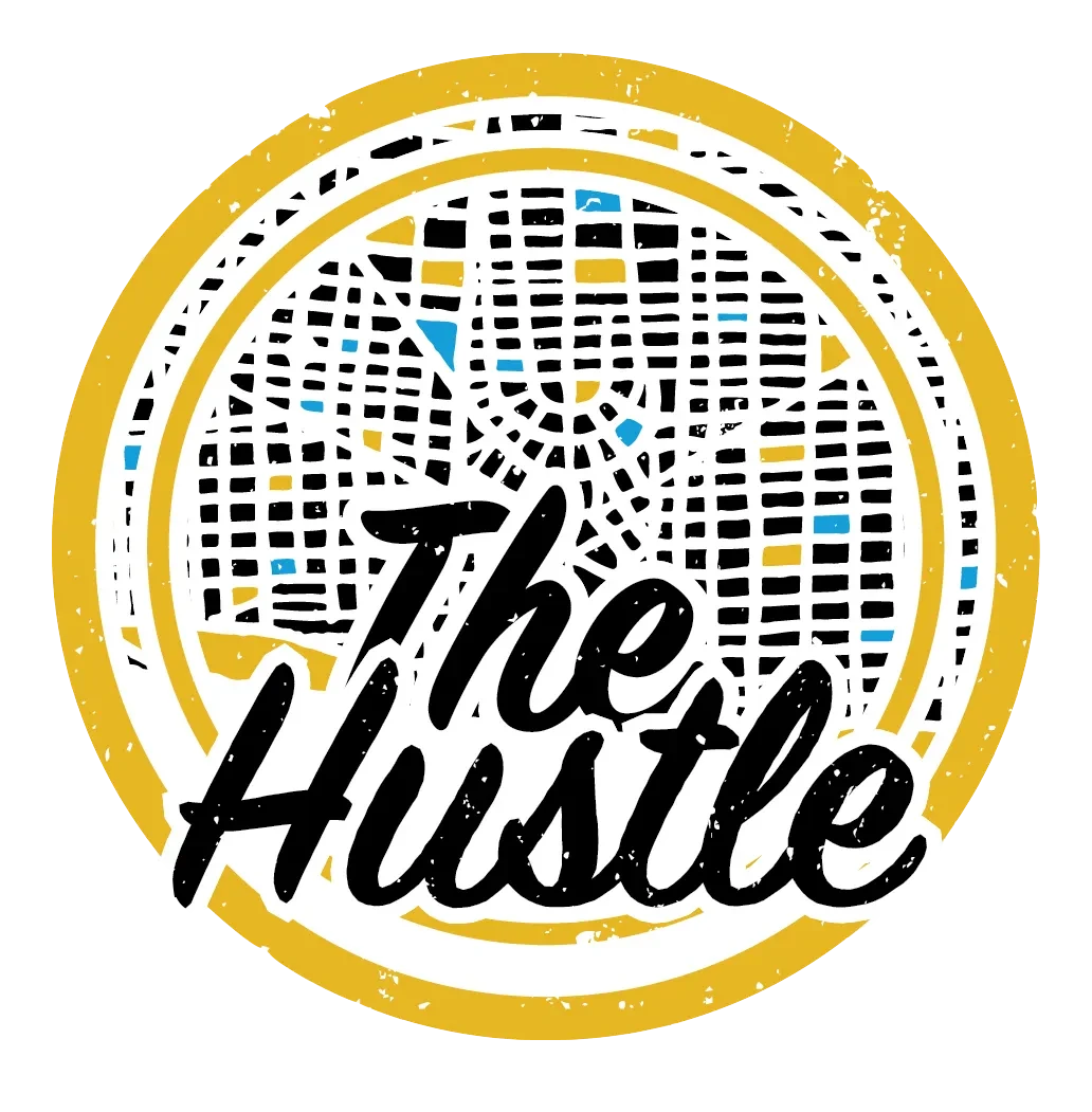 Urban-themed logo with a stylized street map, yellow border, and "The Hustle" text in bold black letters.